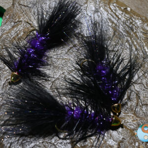 Black Purple Flash Wooly Bugger is a Great Leech Imitation Black Purple Flash Wooly Bugger is tied on a a Dai Riki #4 4XL Hook with long Purple Chenille, Mixed Black and Purple Krystal Flash in the Tail.  Head is 1/4 Gold Cone. American Tied