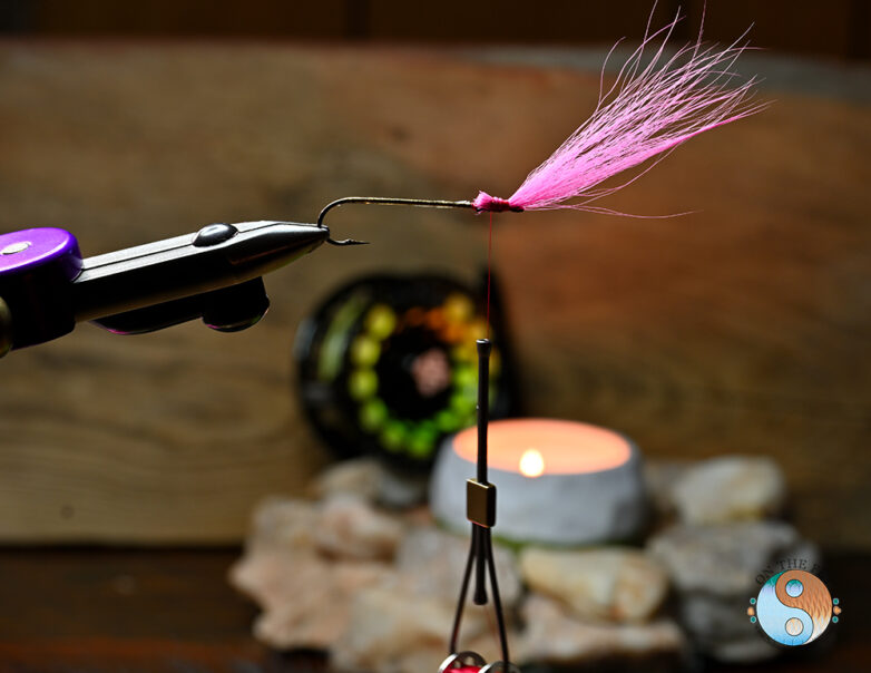 Next step after the lead head is to tie in the Fluorescent Pink Bucktail for the head and back on Thunder Creek Minnow 