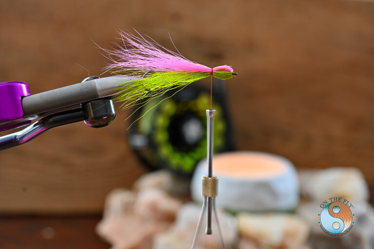 Next Roll over the hook and tied fold back the Fluorescent Pink Bucktail and tied off. At this Point you would add your lateral line flash of choice Saltwater on the Fly