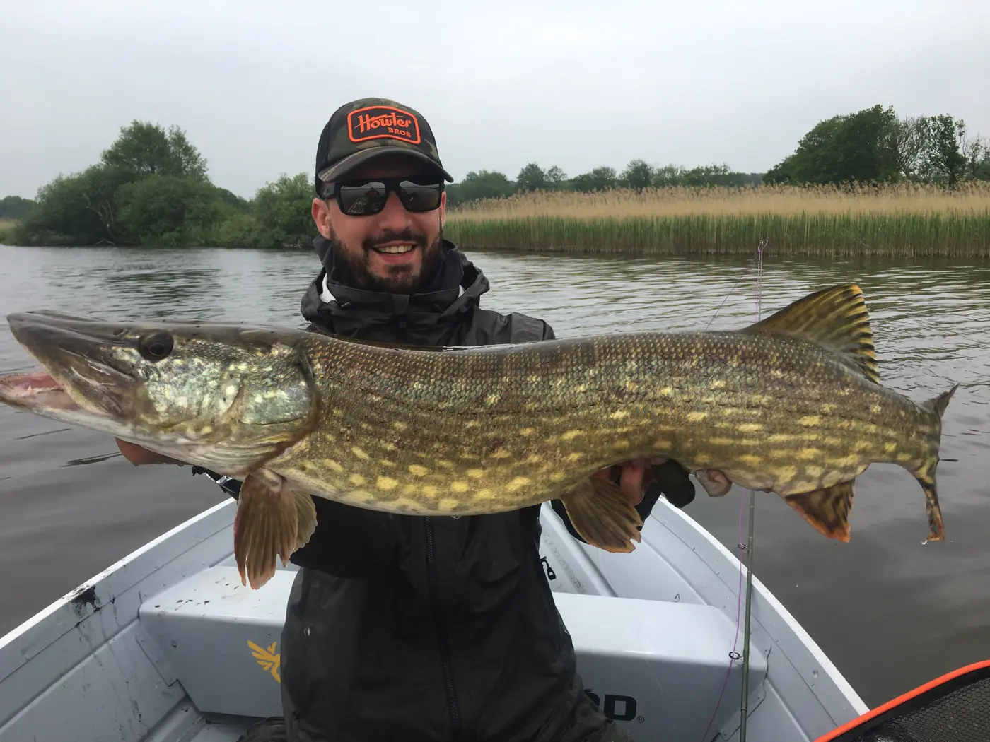 Client with a pike on a fly in Denmark