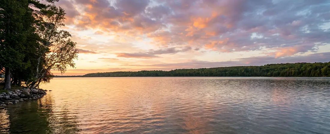 Lake Charlevoix Michigan fishing guide covering bass, northern pike, panfish, walleye, and muskie — with fly fishing tips, seasonal tactics, and the kind of hard-won wisdom that only comes from getting your lunch eaten by a 36-inch pike at age nine.