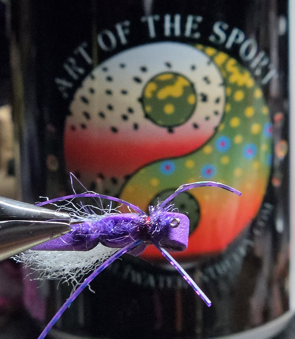 Monster of Purple — a foam-topped slider or twitcher built to float and hunt. Holographic legs, dense bush fur body. Shop it at Saltwater on the Fly.