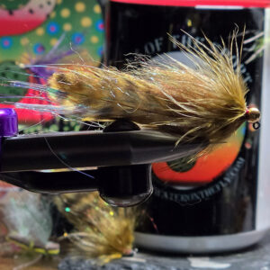 Olive Grizzly Sugar Momma marabou streamer fly with golden olive dubbing and wood duck mallard flank on a Partridge hook, Saltwater on the Fly.