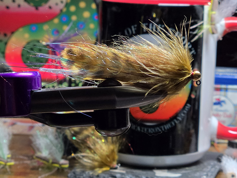 Olive Grizzly Sugar Momma marabou streamer fly with golden olive dubbing and wood duck mallard flank on a Partridge hook, Saltwater on the Fly.
